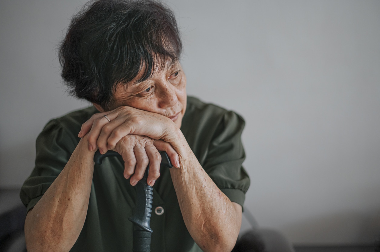 Sad senior woman at home portrait